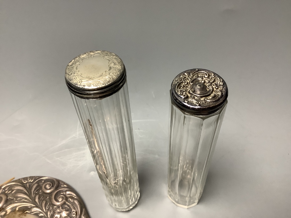 Two silver-topped narrow cylindrical toilet bottles, a silver backed-hand mirror and matching hairbrush, a comb and a silver compact